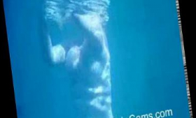 For voyeurs, a thick MILF lies underwater without a top