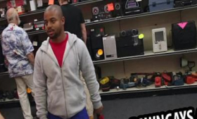 At the pawn shop, a black man tries to sell an ebony bike