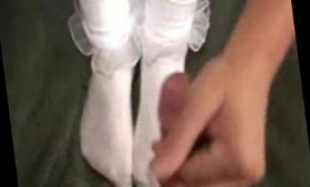 A white footjob with frilly socks