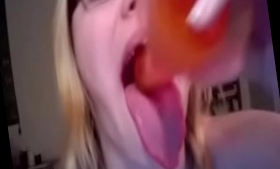 The blonde she is deepthroats a dildo while her tongue is out
