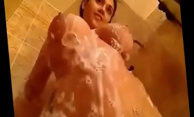 An attractive girl is taking a shower